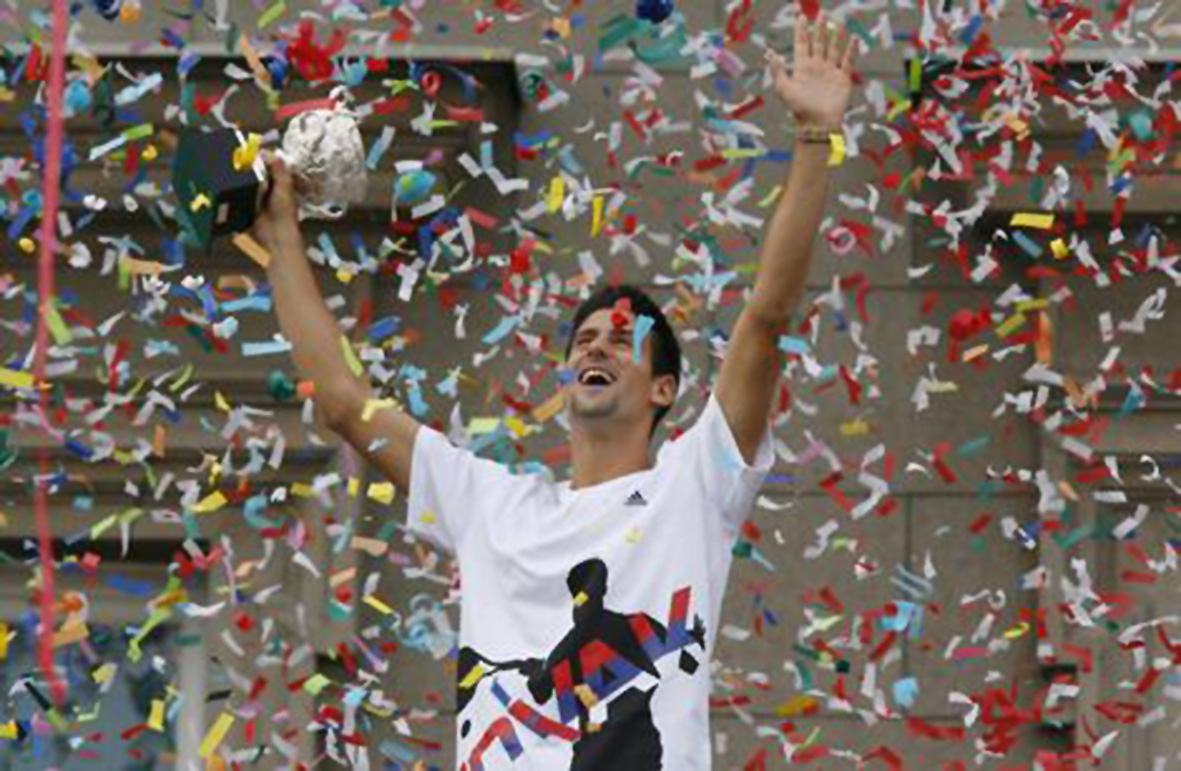 Serbian tennis player Novak Djokovic waves to the crowd during a mass celebration in Belgrade